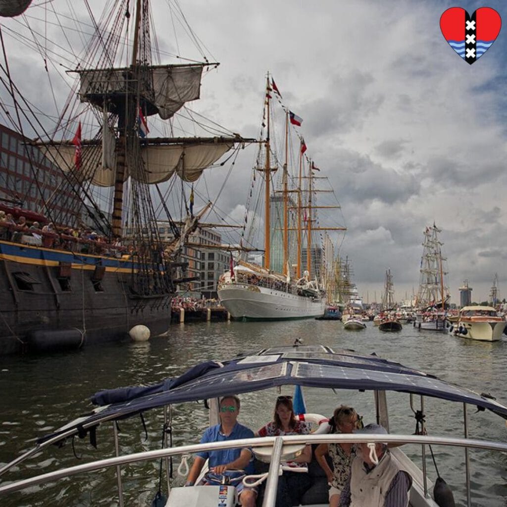 Sailing along the tall ships during SAIL Amsterdam with a private boat tour.